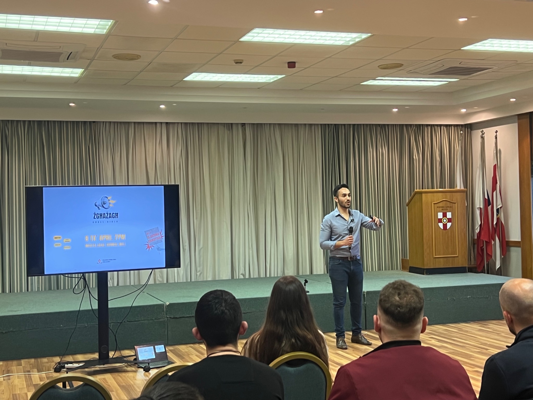 Luke Fenech presenting a youth activism initiative at a public event