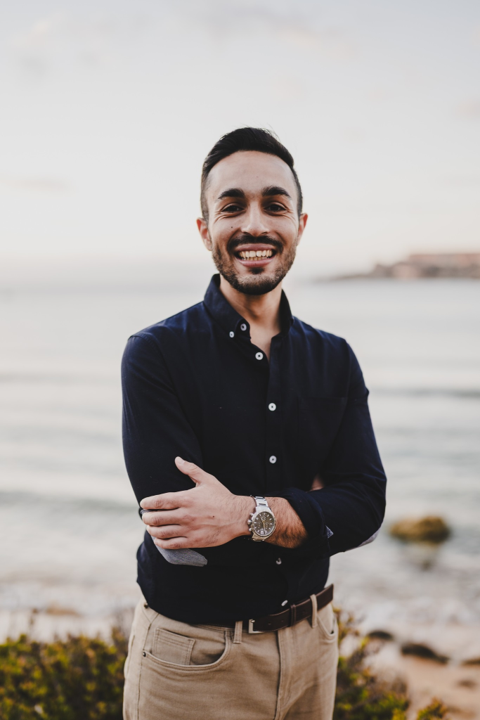 Luke Fenech standing by the Maltese coast